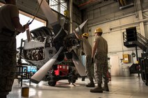 Staff Sgt. Eric Holtz, Airmen 1st Class Daniel Bombeck and Spencer Valentine, 934th Maintenance Squadron, work to remove the propeller from the engine of a retired C-130 aircraft at Minneapolis-St. Paul Air Reserve Station, Minn.  (U.S. Air Force photo/Keith Langsdorf)