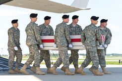 A U.S. Army carry team transfers the remains of Army Sgt. Jamar A. Hicks of Little Rock, Ark., Aug. 14, 2013 at Dover Air Force Base, Del. Hicks was assigned to the 4th Battalion, 320th Field Artillery Regiment, 4th Brigade Combat Team, 101st Airborne Division, Fort Campbell, Ky. (U.S. Air Force photo/Roland Balik)