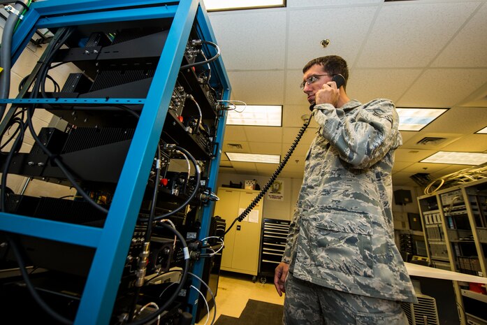 Airman 1st Class Anthony Tressel, 628th Communication Squadron radio frequency transmission systems technician, tests an ultra-high frequency radio used for communicating to aircraft and the command post Aug. 12, 2013, at Joint Base Charleston - Air Base, S.C. The RF transmission systems flight maintains all of the land mobile radio systems covering JB Charleston, as well as public address support. (U.S. Air Force photo/ Senior Airman George Goslin)