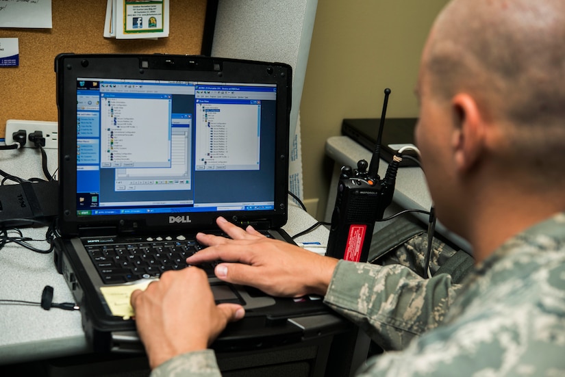 Staff Sgt. Robert Hendrickson, 628th Communication Squadron noncommissioned officer-in-charge of radio frequency transmission systems, reprograms a land mobile radio system Aug. 12, 2013, at Joint Base Charleston - Air Base, S.C. The RF transmission systems flight maintains all of the land mobile radio systems covering JB Charleston, as well as public address support. (U.S. Air Force photo/ Senior Airman George Goslin)