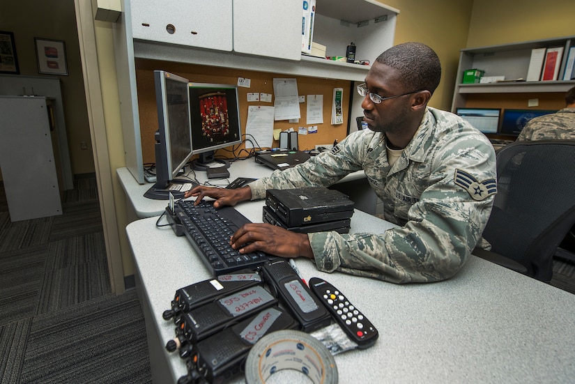 Senior Airman Jamel McCargo, 628th Communications Squadron radio frequency transmission systems technician, searches for codes to reprogram a land mobile radio system Aug. 12, 2013, at Joint Base Charleston - Air Base, S.C. The RF transmission systems flight maintains all of the land mobile radio systems covering JB Charleston, as well as public address support. (U.S. Air Force photo/ Senior Airman George Goslin)