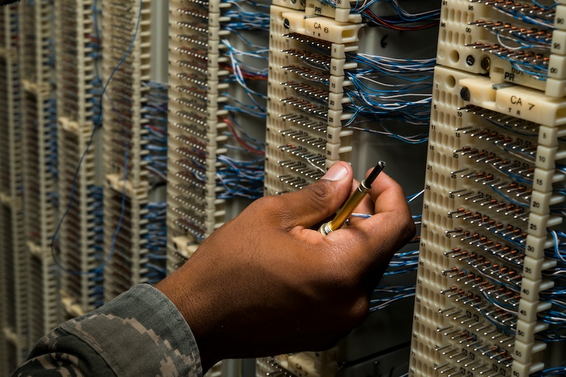 Staff Sgt. Spenser Amos, 628th Communications Squadron cyber transport systems technician, finds a new number location on a line equipment number block Aug. 8, 2013, at Joint Base Charleston - Air Base, S.C. The infrastructure flight maintains all communications cabling which includes copper wiring, inside building cabling, outside building cabling, all telephone switches to include two main systems on the Weapons Station and four main systems on the Air Base for voice systems, as well as a 400 device data network between both sides of the base for more than 200 buildings. (U.S. Air Force photo/ Senior Airman George Goslin)