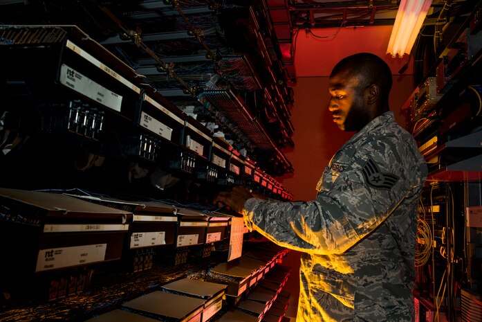 Staff Sgt. Spenser Amos, 628th Communications Squadron cyber transport systems technician, finds a new number location on a line equipment number block Aug. 8, 2013, at Joint Base Charleston - Air Base, S.C. The infrastructure flight maintains all communications cabling which includes copper wiring, inside building cabling, outside building cabling, all telephone switches to include two main systems on the Weapons Station and four main systems on the Air Base for voice systems, as well as a 400 device data network between both sides of the base for more than 200 buildings. (U.S. Air Force photo/ Senior Airman George Goslin)