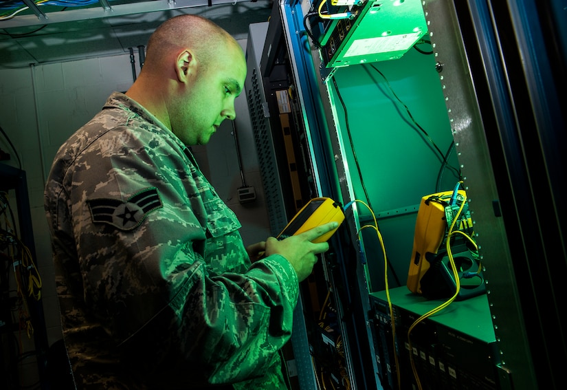 Senior Airman James Collier, 628th Communications Squadron network infrastructure technician, uses a cable analyzer to test for decibel loss on a fiber line Aug. 8, 2013, at Joint Base Charleston - Air Base, S.C. The infrastructure flight maintains all communications cabling which includes copper wiring, inside building cabling, outside building cabling, all telephone switches to include two main systems on the Weapons Station and four main systems on the Air Base for voice systems, as well as a 400 device data network between both sides of the base for more than 200 buildings. (U.S. Air Force photo/ Senior Airman George Goslin)