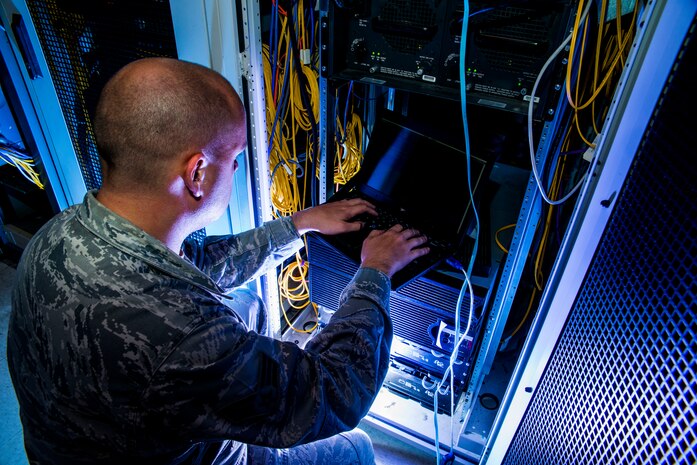 Senior Airman James Collier, 628th Communications Squadron network infrastructure technician, configures a network switch Aug. 8, 2013, at Joint Base Charleston - Air Base, S.C. The infrastructure flight maintains all communications cabling which includes copper wiring, inside building cabling, outside building cabling, all telephone switches to include two main systems on the Weapons Station and four main systems on the Air Base for voice systems, as well as a 400 device data network between both sides of the base for more than 200 buildings. (U.S. Air Force photo/ Senior Airman George Goslin)