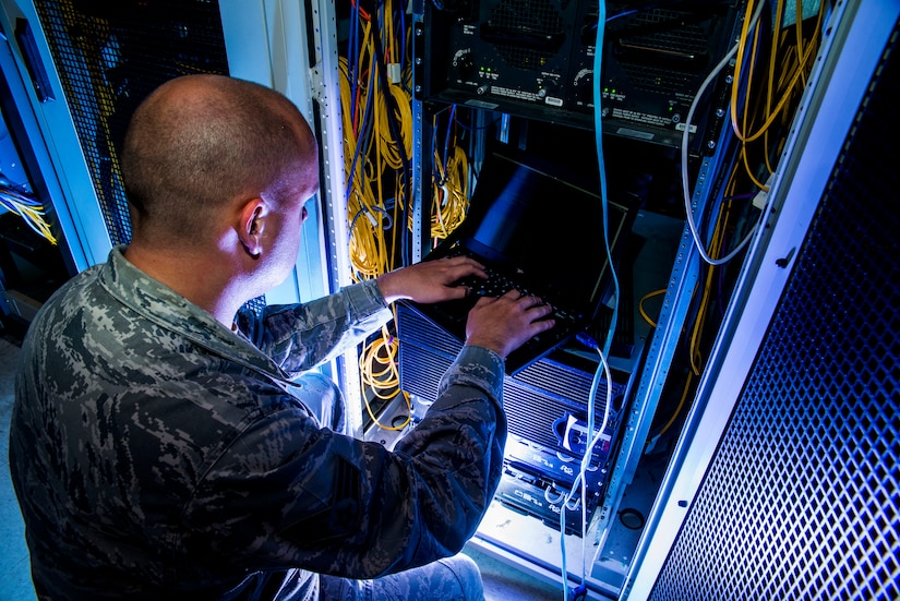 Senior Airman James Collier, 628th Communications Squadron network infrastructure technician, configures a network switch Aug. 8, 2013, at Joint Base Charleston - Air Base, S.C. The infrastructure flight maintains all communications cabling which includes copper wiring, inside building cabling, outside building cabling, all telephone switches to include two main systems on the Weapons Station and four main systems on the Air Base for voice systems, as well as a 400 device data network between both sides of the base for more than 200 buildings. (U.S. Air Force photo/ Senior Airman George Goslin)