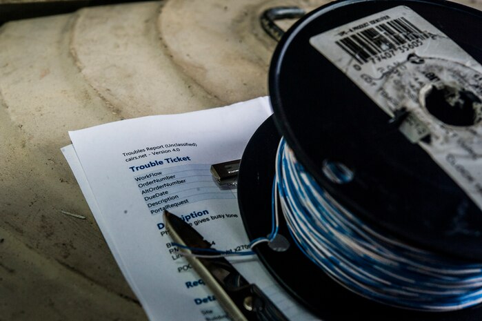 A trouble ticket for a service call is pictured Aug. 8, 2013, at Joint Base Charleston - Air Base, S.C. The infrastructure flight maintains all communications cabling which includes copper wiring, inside building cabling, outside building cabling, all telephone switches to include two main systems on the Weapons Station and four main systems on the Air Base for voice systems, as well as a 400 device data network between both sides of the base for more than 200 buildings. (U.S. Air Force photo/ Senior Airman George Goslin)