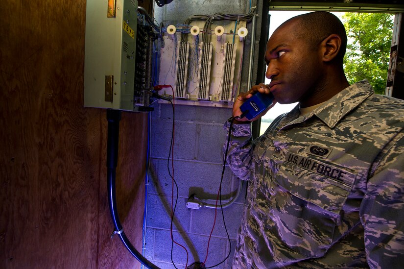 Staff Sgt. Spenser Amos, 628th Communications Squadron cyber transport systems technician, calls his shop while performing maintenance during a trouble ticket call Aug. 8, 2013, at Joint Base Charleston - Air Base, S.C. The infrastructure flight maintains all communications cabling which includes copper wiring, inside building cabling, outside building cabling, all telephone switches to include two main systems on the Weapons Station and four main systems on the Air Base for voice systems, as well as a 400 device data network between both sides of the base for more than 200 buildings. (U.S. Air Force photo/ Senior Airman George Goslin)