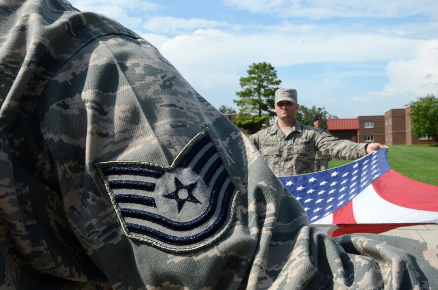 MCGHEE TYSON AIR NATIONAL GUARD BASE, Tenn. - Noncommissioned Officer Academy students fold the flag in the retreat ceremony on campus July 22, 2013, here at the Paul H. Lankford Enlisted Professional Military Education Center.  More than 240 students attended the six week academy that prepares Airmen for the increased responsibilities required of senior noncommissioned officers.  (U.S. Air Force photo by Tech. Sgt. Lakisha A. Croley / Released)   