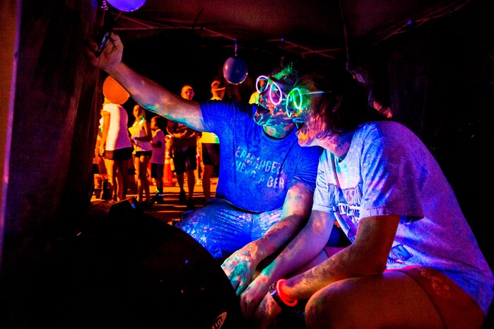 Seaman Andrew Deneen and Seaman Deborah Molstad, Naval Nuclear Power Training Unit students, takes a 'selfie' before the Nuclear Glow 5K, Aug. 9, 2013, at Joint Base Charleston - Weapons Station, S.C. Competitors wore glow-in-the-dark clothing and accessories as they ran through base housing. (U.S. Air Force photo/ Senior Airman George Goslin)