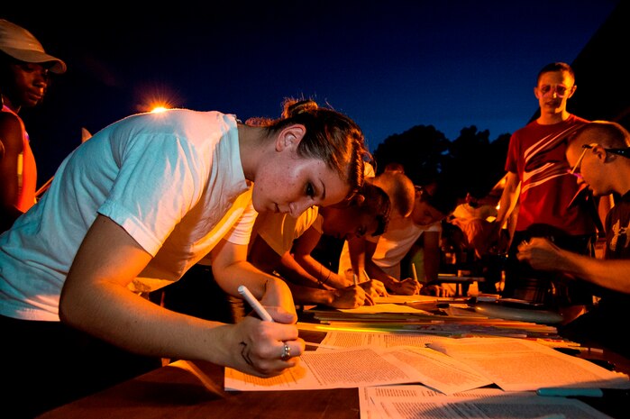 Seaman Melissa Fiorito, Nuclear Power Training  Unit electronics technician, fills out a safety waiver before running the Nuclear Glow 5K race, Aug. 9, 2013, at Joint Base Charleston - Weapons Station, S.C. Competitors wore glow- in- the- dark clothing and accessories as they ran through base housing. (U.S. Air Force photo/ Senior Airman George Goslin)