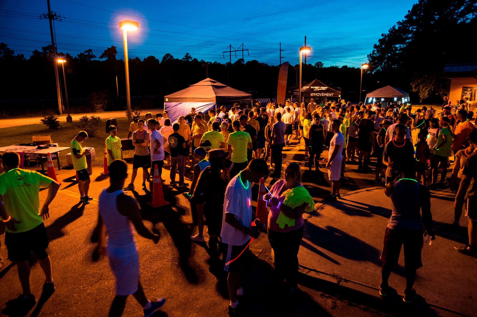 Service members and their families gather at the Nuclear Glow 5K Aug. 9, 2013, at Joint Base Charleston - Weapons Station, S.C. Service members and their families ran through base housing wearing glow- in- the- dark clothing and accessories.  (U.S. Air Force photo/ Senior Airman George Goslin)