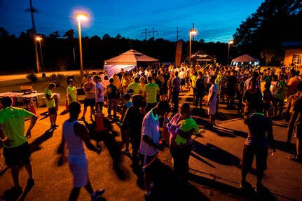 Service members and their families gather at the Nuclear Glow 5K Aug. 9, 2013, at Joint Base Charleston - Weapons Station, S.C. Service members and their families ran through base housing wearing glow- in- the- dark clothing and accessories.  (U.S. Air Force photo/ Senior Airman George Goslin)