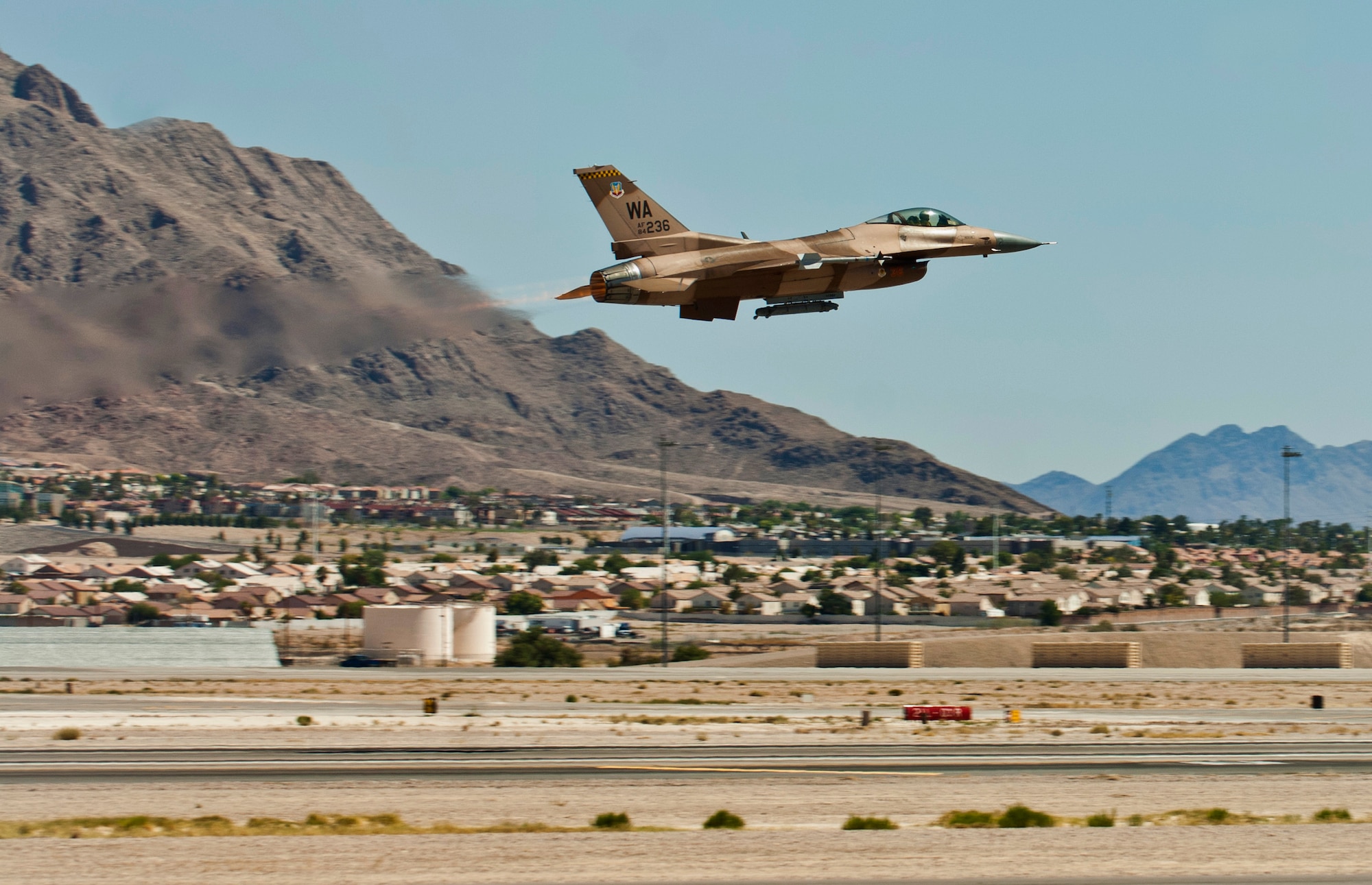 An F-16 Fighting Falcon assigned to the 64th Aggressor Squadron takes off for a training flight Aug. 13, 2013, at Nellis Air Force Base, Nev. Aggressor pilots utilize adversary tactics and act as hostile forces during air-combat exercises. (U.S. Air Force photo by Airman 1st Class Joshua Kleinholz)
