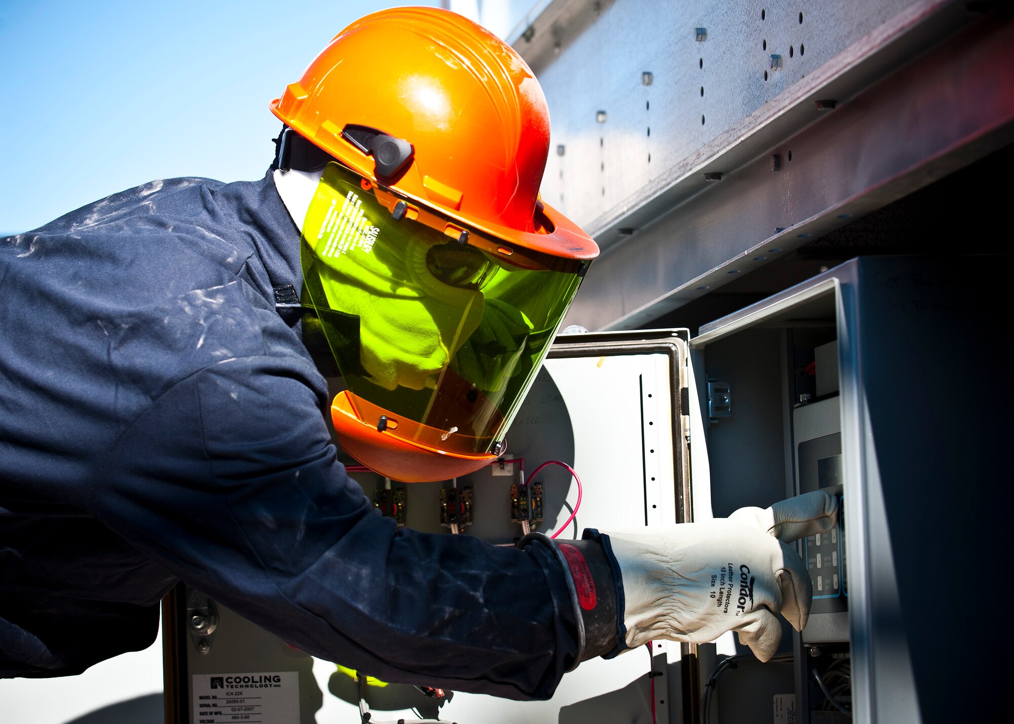 Airman 1st Class Joseph Phillips, 99th Civil Engineer Squadron heating, ventilation, air conditioning and refrigeration apprentice, checks the temperature and pressure of a cooling unit at the 99th Logistics Readiness Squadron vehicle maintenance building Aug. 13, 2013, at Nellis Air Force Base, Nev. The HVAC/R unit conducts quarterly inspections on cooling systems to ensure maximum capability across the installation. (U.S. Air Force photo/Senior Airman Brett Clashman)