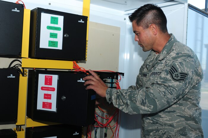 Staff Sgt. Forest Decker, 222nd Communications Maintenance Squadron cyber transport technician, checks a fiber optic patch panel in the Hoffman Box at Beale Air Force Base, Calif., Aug. 13, 2013. Decker is competing for the 222nd CMXS NCO of the Year award. (U.S. Air Force photo by Senior Airman Allen Pollard/Released)