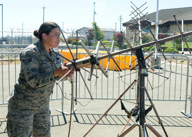 Senior Airman Yurina Zamora, 222nd Communications Maintenance Squadron radio frequency technician for the Global Hawk, aligns an ultra high frequency satellite communication antenna at Beale Air Force Base, Calif., Aug. 13, 2013. Zamora is competing for the 22nd CMXS Airman of the Year award. (U.S. Air Force photo by Senior Airman Allen Pollard/Released)
