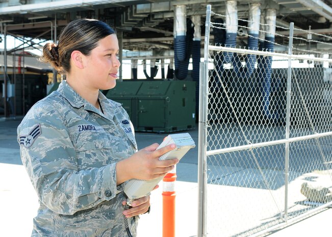 Senior Airman Yurina Zamora, 222nd Communications Maintenance Squadron radio frequency technician for the Global Hawk, aligns a tactical field terminal antenna at Beale Air Force Base, Calif., Aug. 13, 2013. The TFT antennas are used to set up a communication link between the mission control element and the aircraft. (U.S. Air Force photo by Senior Airman Allen Pollard/Released)