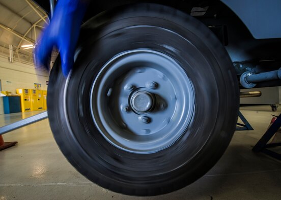 Airman 1st Class Charles Cannon, 437th Maintenance Squadron Aerospace Ground Equipment technician, spins the tire to make sure the repacked wheel bearing is working properly and the tire is moving with ease Aug. 6, 2013, at Joint Base Charleston – Air Base, S.C. (U.S. Air Force photo/Senior Airman Dennis Sloan) 

