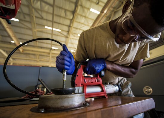 Airman 1st Class Charles Cannon, 437th Maintenance Squadron Aerospace Ground Equipment technician, uses an electronic grease gun to reapply new grease to wheel bearing parts Aug. 6, 2013, at Joint Base Charleston – Air Base, S.C. (U.S. Air Force photo/Senior Airman Dennis Sloan) 

