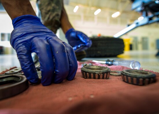 Airman 1st Class Charles Cannon, 437th Maintenance Squadron Aerospace Ground Equipment technician, places wheel bearing parts on a rag to inspect and clean Aug. 6, 2013, at Joint Base Charleston – Air Base, S.C. Cannon removed all the old grease from the bearing and placed the parts in a special washing machine that uses a chemical solvent to remove all the grease. (U.S. Air Force photo/Senior Airman Dennis Sloan) 

