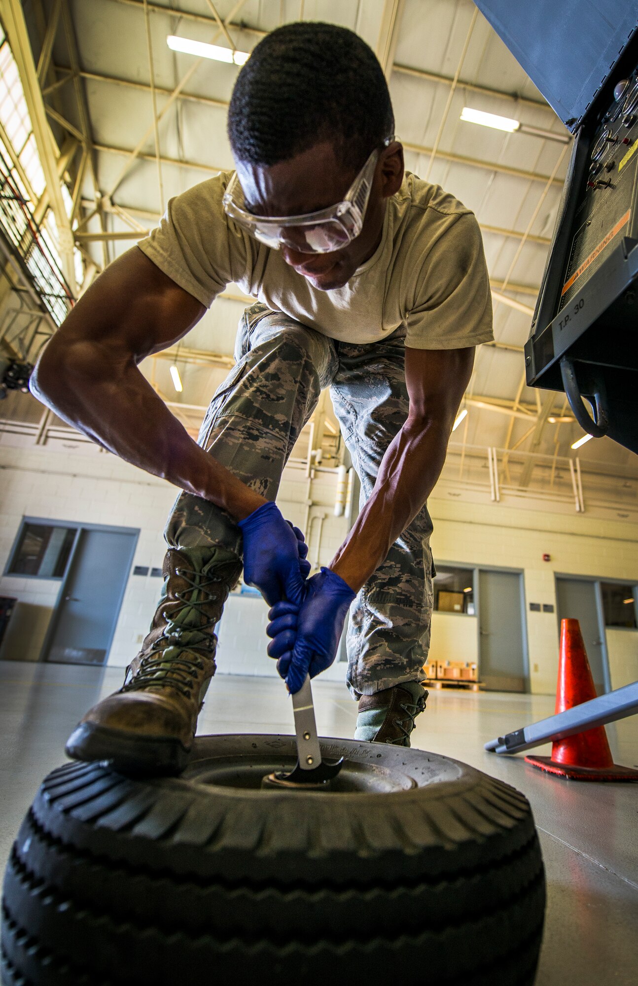 Airman 1st Class Charles Cannon, 437th Maintenance Squadron Aerospace Ground Equipment technician, pries a wheel bearing out of a wheel assembly of a floodlight vehicle Aug. 6, 2013, at Joint Base Charleston – Air Base, S.C. The floodlight vehicle is used by maintainers on the flightline at night or in low-light areas while they perform maintenance on C-17 Globemaster III’s. (U.S. Air Force photo/ Senior Airman Dennis Sloan)