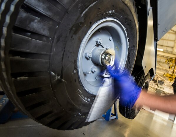 Airman 1st Class Charles Cannon, 437th Maintenance Squadron Aerospace Ground Equipment technician, uses a crescent wrench to remove a bolt on a wheel assembly Aug. 6, 2013, at Joint Base Charleston – Air Base, S.C. Cannon needed to remove the tire to clean and inspect a bearing. (U.S. Air Force photo/ Senior Airman Dennis Sloan)