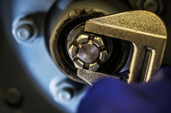 Airman 1st Class Charles Cannon, 437th Maintenance Squadron Aerospace Ground Equipment technician, uses a crescent wrench to remove a bolt on a wheel assembly Aug. 6, 2013, at Joint Base Charleston – Air Base, S.C. Cannon needed to remove the tire to clean and inspect a bearing. (U.S. Air Force photo/ Senior Airman Dennis Sloan)