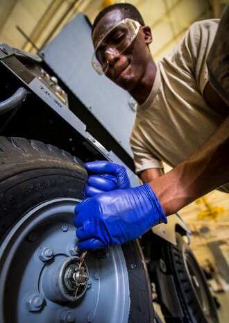 Airman 1st Class Charles Cannon, 437th Maintenance Squadron Aerospace Ground Equipment technician, removes the cotter pin from a wheel Aug. 6, 2013, at Joint Base Charleston – Air Base, S.C. Cannon needed to remove the tire to clean and inspect a bearing. (U.S. Air Force photo/ Senior Airman Dennis Sloan)