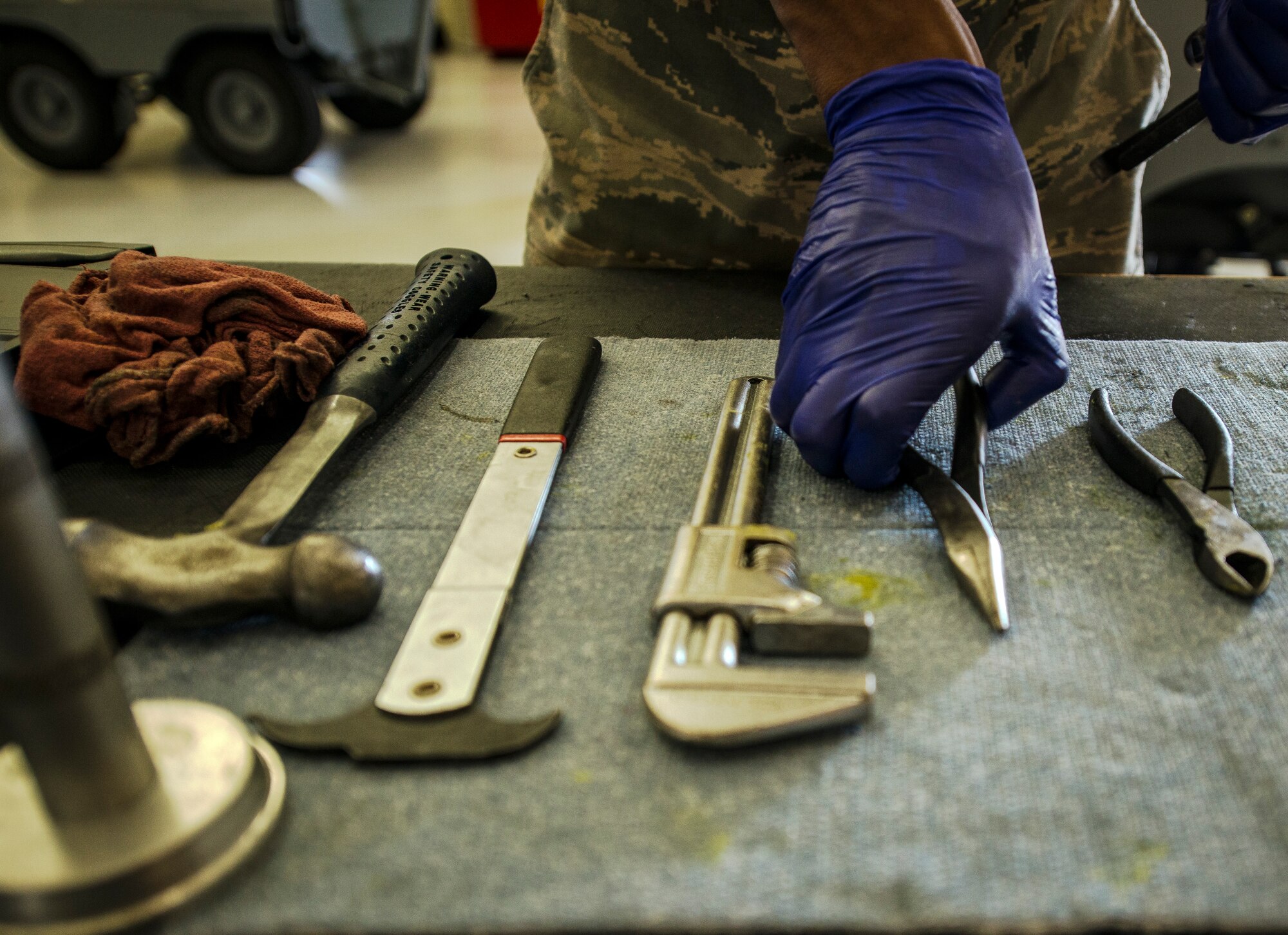 Airman 1st Class Charles Cannon, 437th Maintenance Squadron Aerospace Ground Equipment technician, prepares the tools he needs to remove a wheel assembly from a floodlight vehicle Aug. 6, 2013, at Joint Base Charleston – Air Base, S.C. Cannon needed to remove the tire to clean and inspect a bearing. (U.S. Air Force photo/ Senior Airman Dennis Sloan)