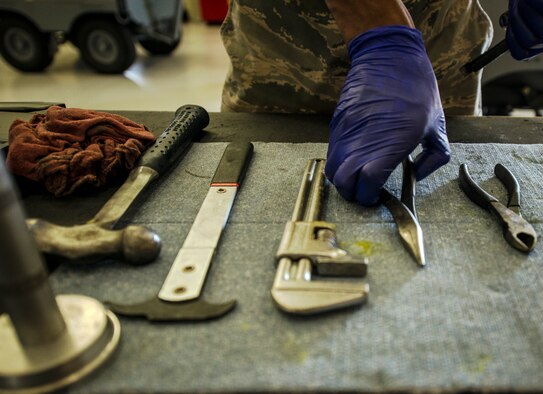 Airman 1st Class Charles Cannon, 437th Maintenance Squadron Aerospace Ground Equipment technician, prepares the tools he needs to remove a wheel assembly from a floodlight vehicle Aug. 6, 2013, at Joint Base Charleston – Air Base, S.C. Cannon needed to remove the tire to clean and inspect a bearing. (U.S. Air Force photo/Senior Airman Dennis Sloan) 

