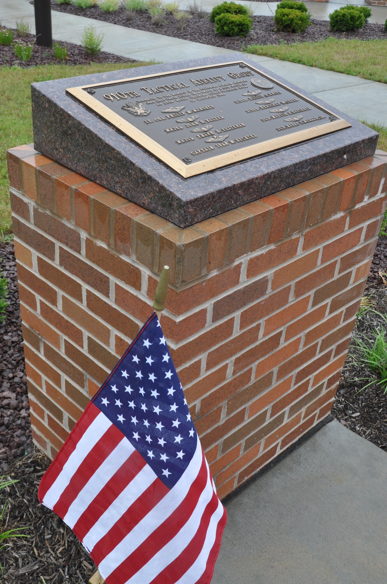 YOUNGSTOWN AIR RESERVE STATION, Ohio -- A flag is displayed next to a memorial marker here during a ceremony honoring fallen members of the heritage units of the 757th Airlift Squadron, July 27, 2013. The memorial marker is located near the 910th Airlift Wing headquarters building flagpole.  The ceremony was hosted by the 757th Veteran’s Association, which is celebrating its 30th anniversary this year.