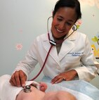 Maj. (Dr.) Dorka Jimenez, 5th Medical Operations Squadron Pediatrican, performs a well-baby examine on one of the 5th Medical Group's newest patients. (U.S. Air Force photo/Airman 1st Class Andrew Crawford)