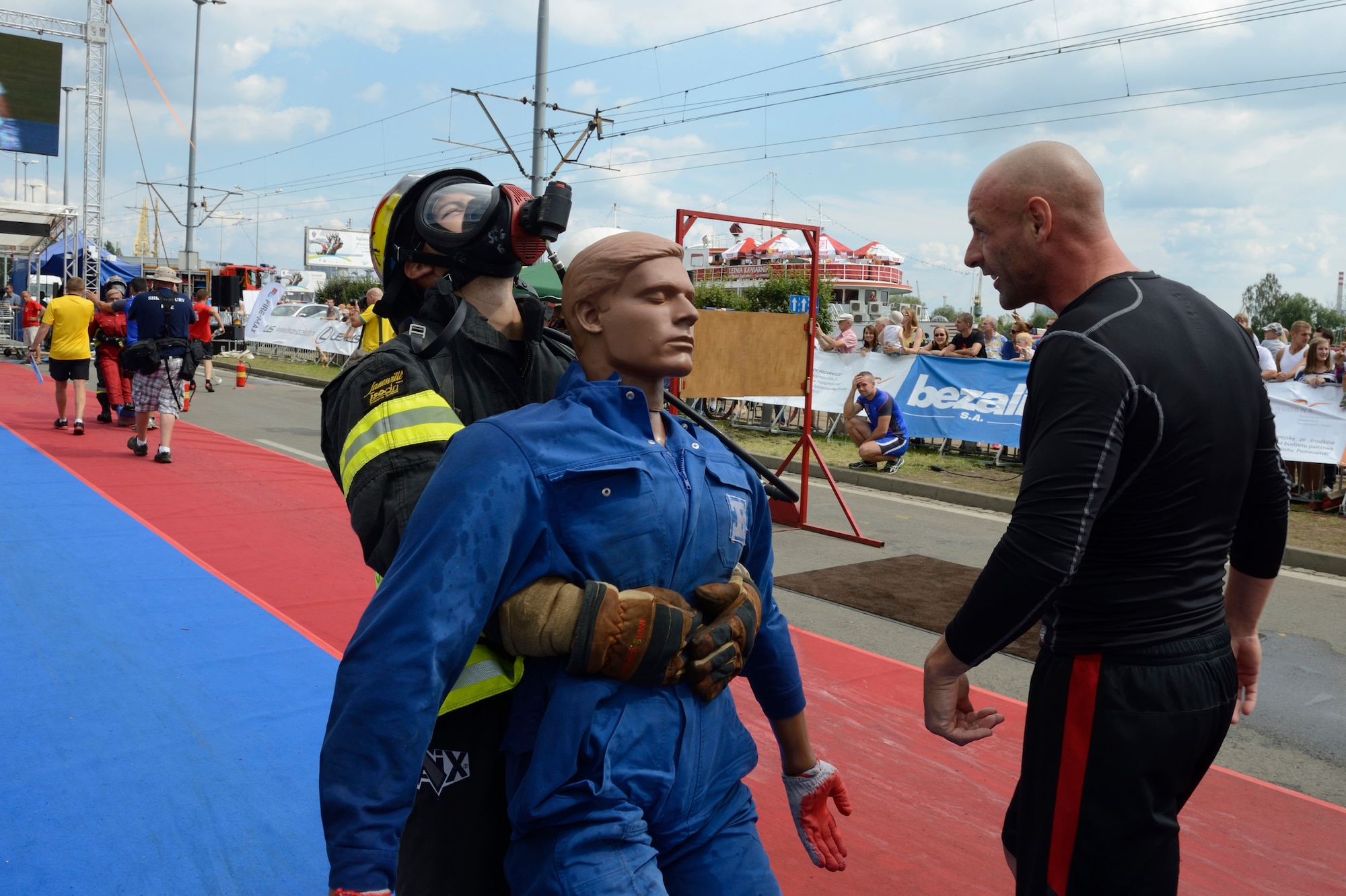 SPANGDAHLEM AIR BASE, Germany – Gerd Mueller, 52nd Civil Engineer Squadron firefighter crew chief from Gransdorf, Germany, encourages U.S. Air Force Staff Sgt. Benjamin Gonsales, 52nd Civil Engineer Squadron firefighter from Savannah, Ga., during the victim rescue obstacle while participating in the Szczecin Firefighter Combat Challenge in Szczecin, Poland Aug. 10, 2013. The Spangdahlem team ranked 11th out of 36 teams comprising of more than 4 countries. (U.S. Air Force photo by Staff Sgt. Christopher Ruano/Released)