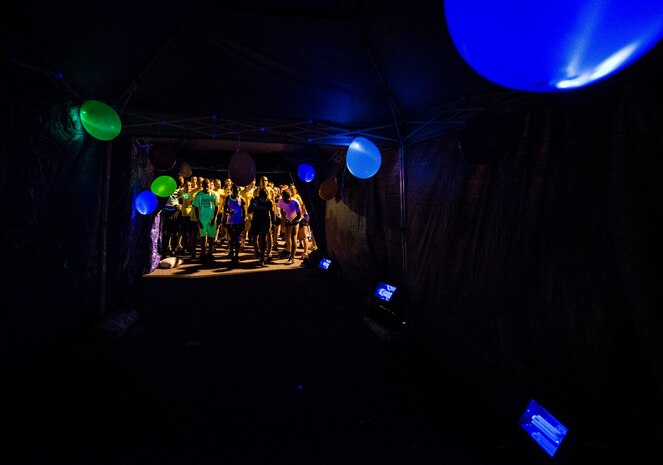 Service members and their families gather at the starting line of the Nuclear Glow 5K Aug. 9, 2013, at Joint Base Charleston – Weapons Station, S.C. Service members and their families ran through base housing wearing glow-in-the-dark clothing and accessories. (U.S. Air Force photo/ Senior Airman Dennis Sloan)