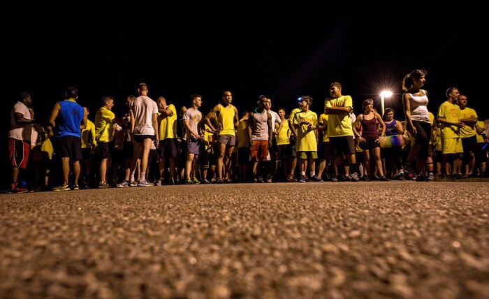 Service members and their families gather at the starting line of the Nuclear Glow 5K Aug. 9, 2013, at Joint Base Charleston – Weapons Station, S.C. Service members and their families ran through base housing wearing glow-in-the-dark clothing and accessories. (U.S. Air Force photo/ Senior Airman Dennis Sloan)