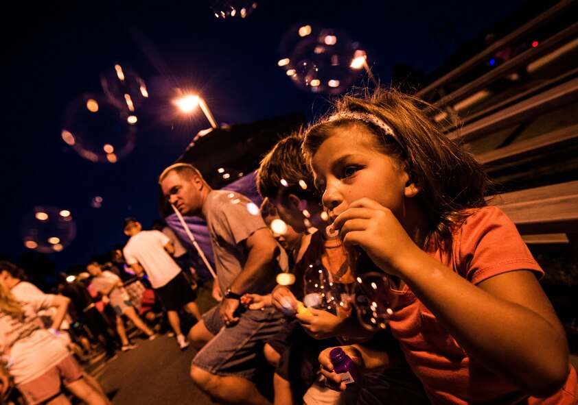 Petty Officer 1st Class Taylor Craig’s children Sidney, age 6, Rhyder, age 9, and Max, age 5, blow bubbles before the start of the Nuclear Glow 5K Aug. 9, 2013, at Joint Base Charleston – Weapons Station, S.C. Service members and their families ran through base housing wearing glow-in-the-dark clothing and accessories. Craig is assigned to the Naval Consolidated Brig Charleston. (U.S. Air Force photo/ Senior Airman Dennis Sloan)