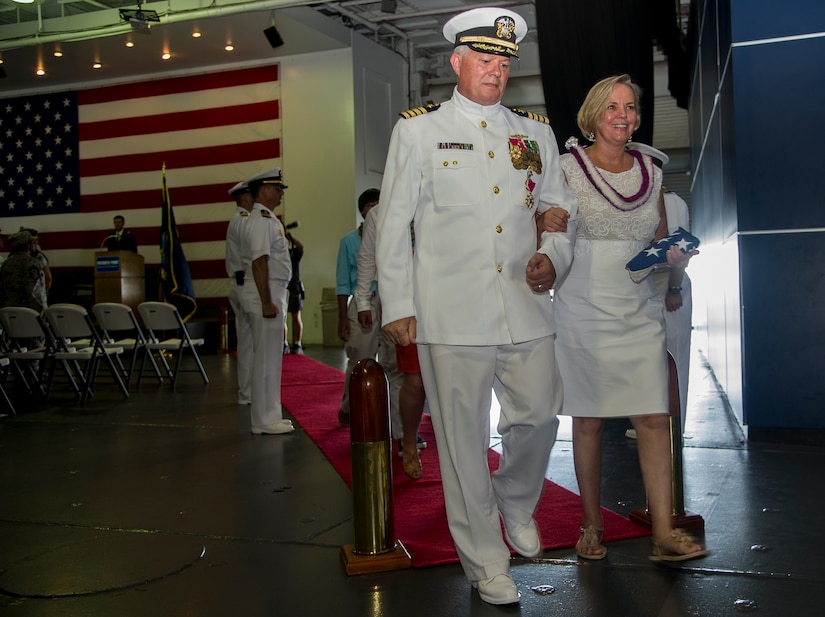 Capt. Thomas Bailey, Joint Base Charleston deputy commander and former Naval Weapons Station commanding officer and his wife Janet, are piped ashore at the conclusion of his retirement ceremony Aug. 9, 2013, aboard the USS Yorktown (CV 10) at Patriots Point Naval and Maritime Museum, Mount Pleasant, S.C. “Piping Ashore" is a historical and traditional naval ceremony that began in the 1700's. Traditionally, the retiree requests permission to "go ashore" for the last time, symbolizing the end of a naval career. Bailey served more than 30 years in the U.S. Navy. (U.S. Air Force photo/Tech. Sgt. Rasheen Douglas)
