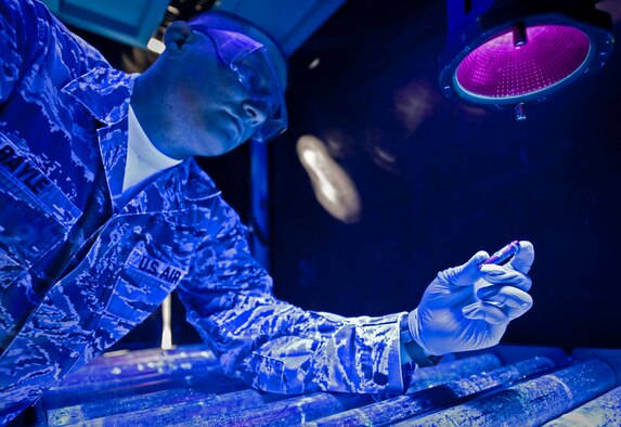 Staff Sgt. David Bayle inspects an aircraft pin for cracks under a black light after dipping the part into chemicals mixed to show cracks not normally visible to the naked eye at the 379th Air Expeditionary Wing in Southwest Asia, Aug. 6, 2013. Bayle is a 379th Expeditionary Maintenance Squadron nondestructive inspection craftsman deployed from Eielson Air Force Base, Alaska, and hails from Port Sanilac, Mich. (U.S. Air Force photo/Senior Airman Benjamin Stratton)