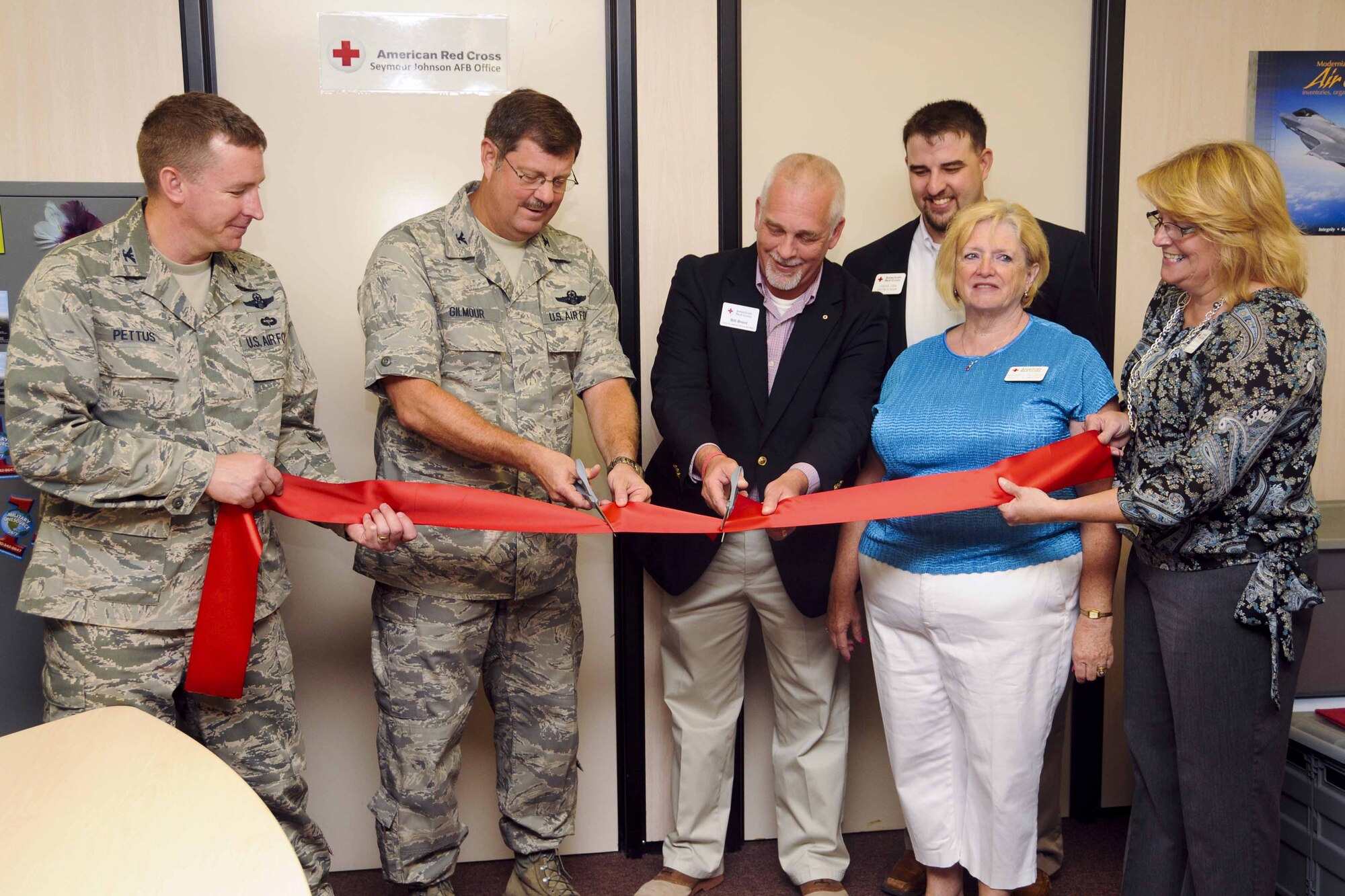 Leadership from the 916th Air Refueling Wing, 4th Fighter Wing and local American Red Cross cut the ribbon on the Red Cross's new office located in the 916th ARW Headquarters building on Aug. 9, 2013. (USAF photo by TSgt.Scotty Sweatt, 916ARW/PA)