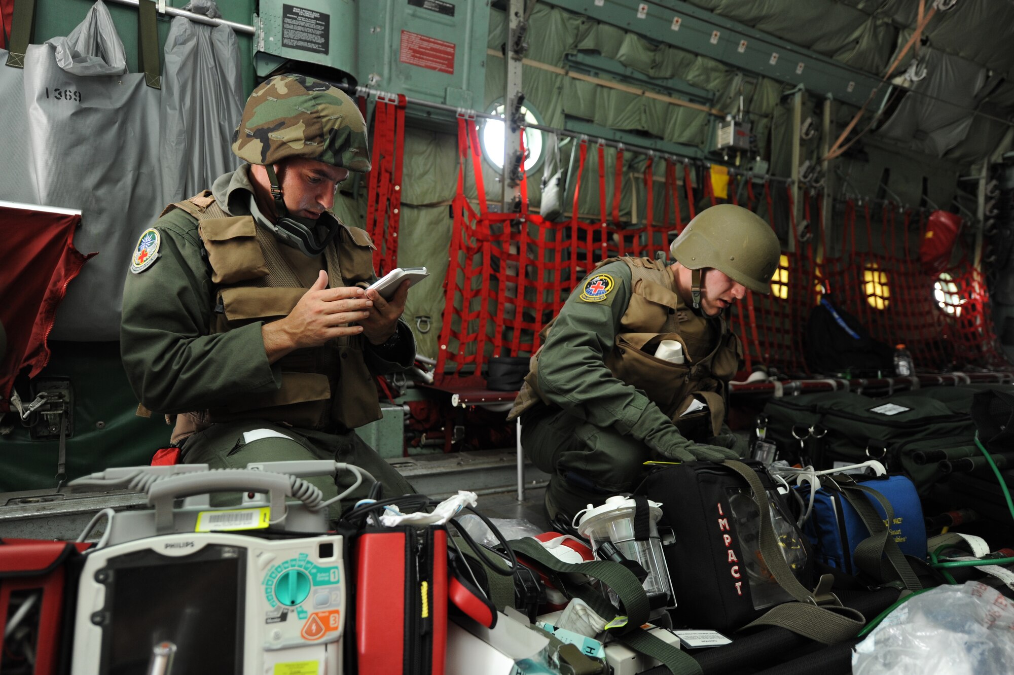 Aeromedical Evacuation Formal Training Unit students 2nd Lt. Carl Konieckza and Senior Airman Michael Turry go through their checklist and equipment to make sure everything is in its place and secure during a simulation exercise here Aug. 5. The simulation gives students realistic practice on scenarios that may happen while in the aircraft. (U.S. Air Force photo by Tech. Sgt. Peter Miller)
