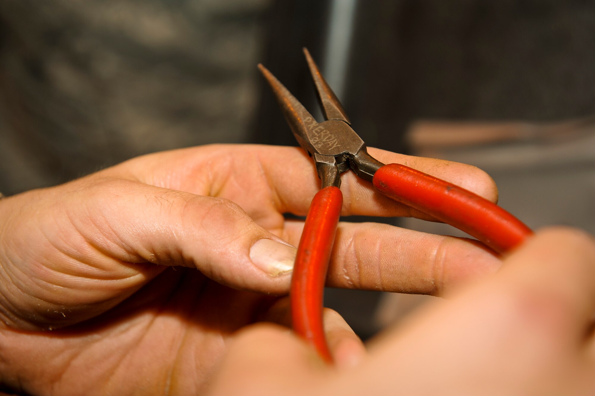 Airman 1st Class Steven Stanfa inspects a pair of needle-nose pliers as he returns a tool kit to the consolidated tool kit at the 379th Air Expeditionary Wing in Southwest Asia, Aug. 8, 2013. Stanfa is an 8th Expeditionary Air Mobility Squadron CTK debriefer deployed from Joint Base Lewis-McChord, Wash., and hails from Rock Island, Tenn. (U.S. Air Force photo/Senior Airman Benjamin Stratton)