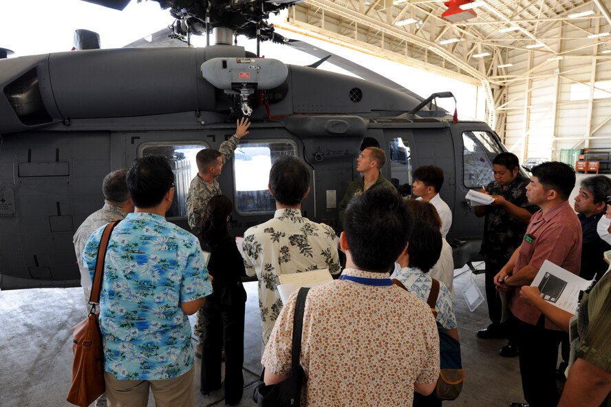 U.S. Air Force Master Sgt. Ct Kirk, 718th Aircraft Maintenance Squadron 33rd Helicopter Maintenance Unit production superintendent, briefs local media about the different components of the HH-60G Pave Hawk helicopter during a media brief at Kadena Air Base, Japan, Aug. 14, 2013. The local media was invited to see the helicopter and have questions answered about the aircraft. (U.S. Air Force photo by Malia S. Jenkins/Released)