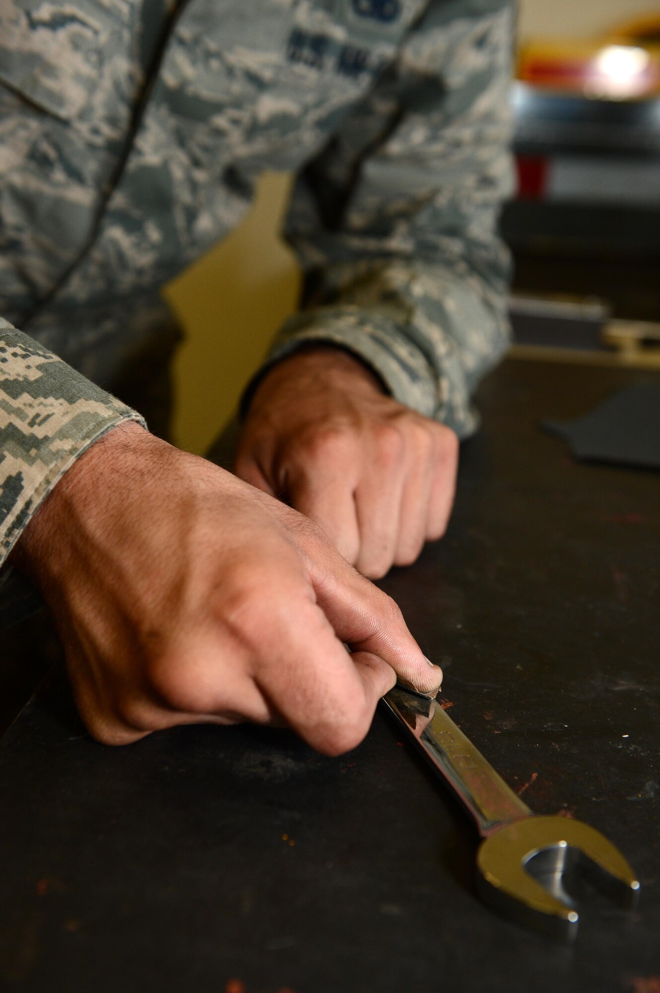 SPANGDAHLEM AIR BASE, Germany – U.S. Air Force Staff Sgt. Jeffrey Brant, 726th Air Mobility Squadron composite tool kit custodian from Millerton Pa., removes rust from a wrench Aug. 13, 2013. Without fixing and maintaining tools, aircraft maintenance units would not be able to fix the aircraft in need of repair. (U.S. Air Force photo by Airman 1st Class Kyle Gese/Released)