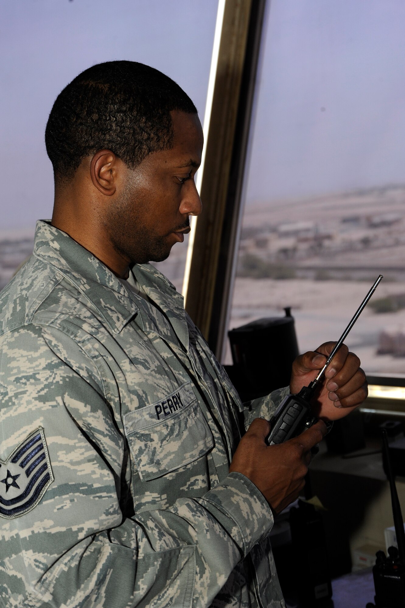 Tech. Sgt. Andre Perry, 386th Expeditionary Operations Support Squadron, air traffic control liaison officer, listens to his Land Mobile Radio here, Aug. 9, 2013.  Perry uses his radio to coordinate movement with aircraft and vehicles.  Perry, a native of Portsmouth Va., is deployed out of the 22nd Air Refueling Wing, McConnell Air Force Base, Kan. (U.S. Air Force photo by Master Sgt. Christopher A. Campbell)