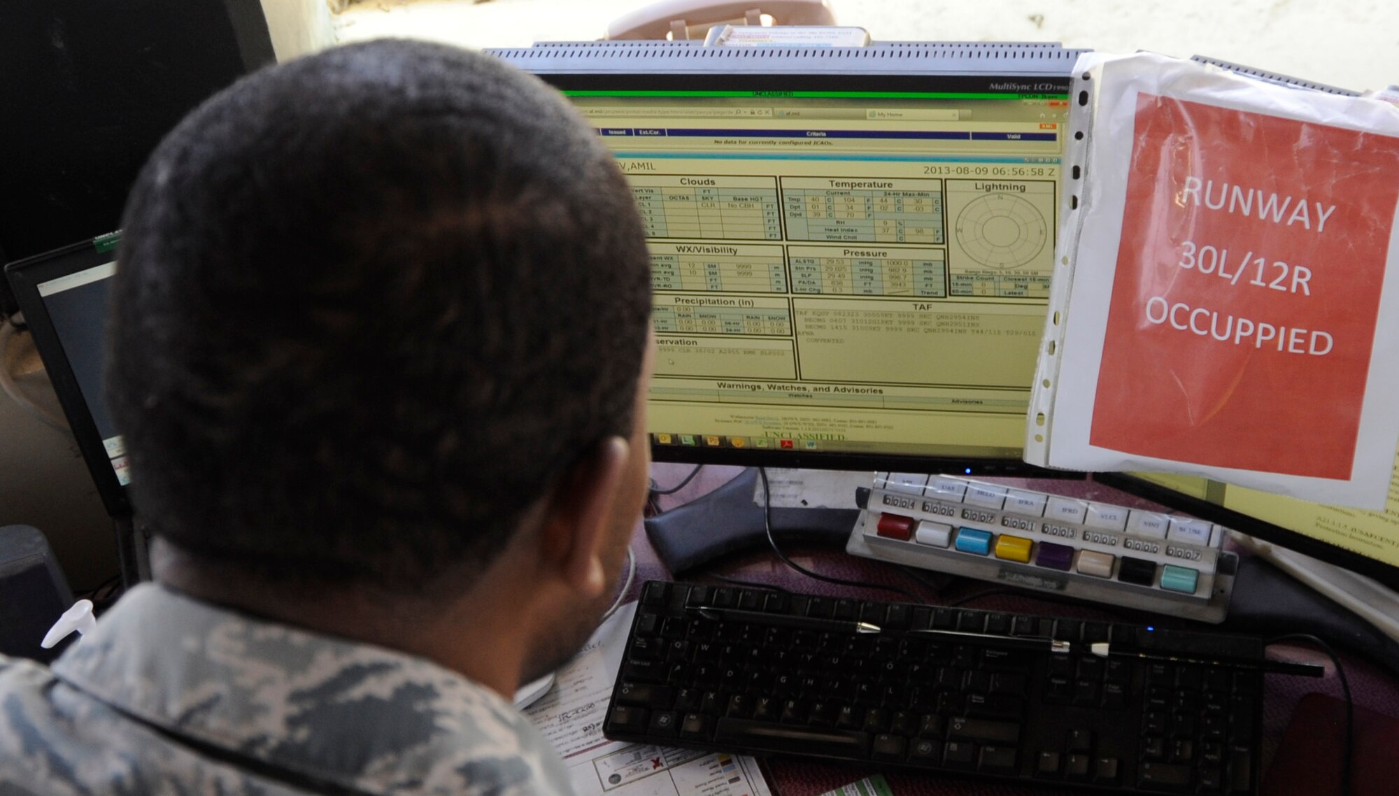 Tech. Sgt. Andre Perry, 386th Expeditionary Operations Support Squadron, air traffic control liaison officer, reviews the current weather and forecast on the Joint Environmental Toolkit here, Aug. 9, 2013.  Perry needs to keep abreast of current and forecasted weather for all aircraft in his area of responsibility.  Perry, a native of Portsmouth Va., is deployed out of the 22nd Air Refueling Wing, McConnell Air Force Base, Kan.  (U.S. Air Force photo by Master Sgt. Christopher A. Campbell)