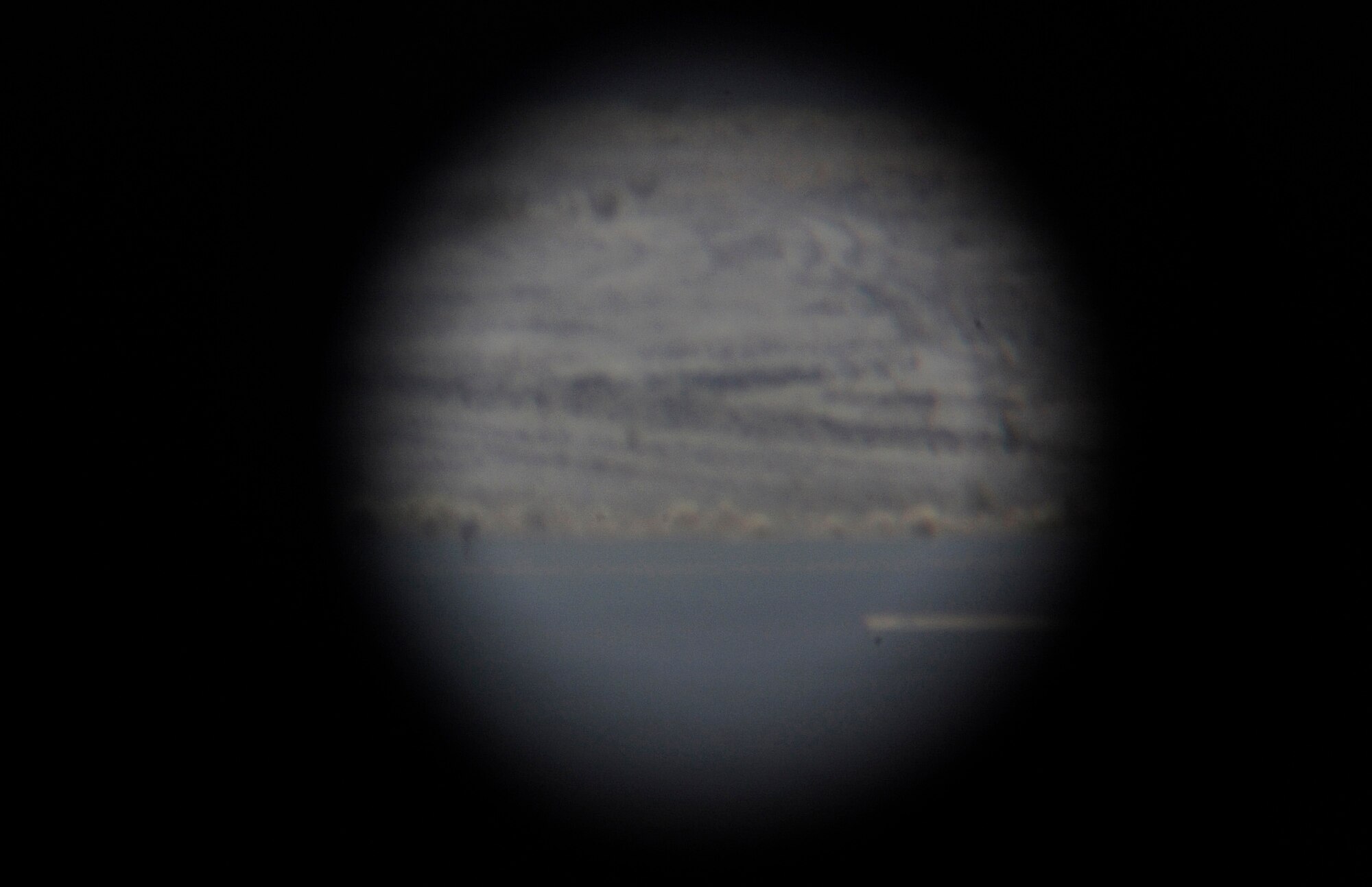 View from the binoculars that Tech. Sgt. Andre Perry, 386th Expeditionary Operations Support Squadron, air traffic control liaison officer, uses here, Aug. 9, 2013.  Perry uses binoculars to ensure there are no foreign objects or animals on the landing strip prior to aircraft taking off or landing. Perry, a native of Portsmouth, Va., is deployed out of the 22nd Air Refueling Wing, McConnell Air Force Base, Kan.  (U.S. Air Force photo by Master Sgt. Christopher A. Campbell)