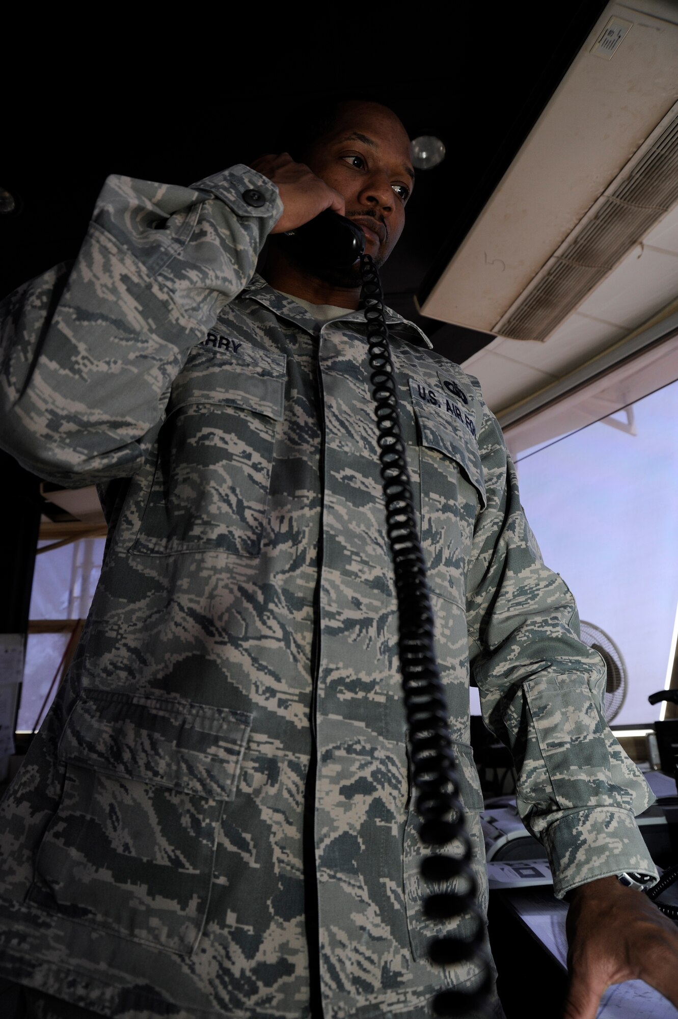 Tech. Sgt. Andre Perry, 386th Expeditionary Operations Support Squadron, air traffic control liaison officer, coordinates with various agencies here, Aug. 9, 2013. Perry organizes aircraft movements with host nation and coalition facilities on and off station to help the mission run smoothly.  Perry, a native of Portsmouth, Va., is deployed out of the 22nd Air Refueling Wing, McConnell Air Force Base, Kan.  (U.S. Air Force photo by Master Sgt. Christopher A. Campbell)
