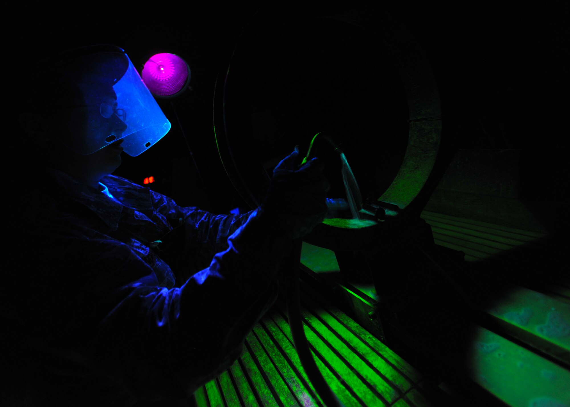Senior Airman Whitnie Hendricks, 51st Maintenance Squadron nondestructive inspection journeyman, prepares to administer a magnetic particle inspection on a bolt from an F-16 Fighting Falcon at the NDI lab at Osan Air Base, Republic of Korea, Aug. 13, 2013. Using eddy current, magnetic particle, radiographic and ultrasonic test equipment, along with liquid penetrant and X-ray, the team can look for small cracks and defects in aircraft and weapons systems components that are invisible to the naked eye. (U.S. Air Force photo/Senior Airman Siuta B. Ika)