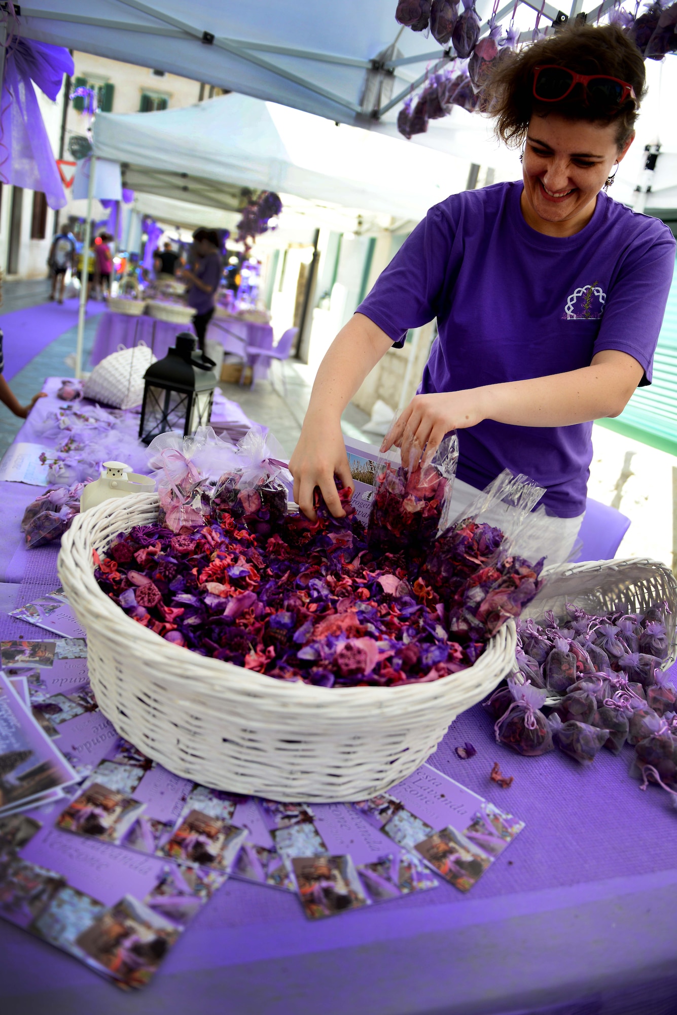 A vendor bags lavender potpourri at the Lavender Festival, Aug. 11, 2013, at Venzone, Italy.  Venzone celebrates the lavender harvest with a festival that decorates the town’s center with a variety of purple decorations.  (U.S. Air Force photo/Staff Sgt. Evelyn Chavez)